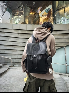 Detail of premium lychee texture leather backpack with drawstring closure and flap cover