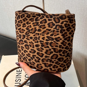Chic leopard print bucket bag with brown leather strap for vintage fashion styling