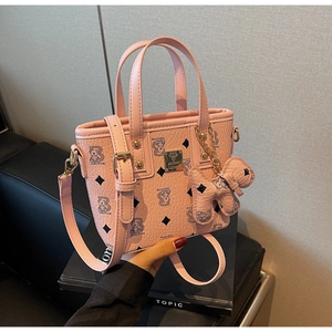 Detail showing pink PU leather bag with diamond bear pattern and small teddy charm accessory