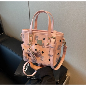 Pink pebbled leather mini bucket bag with cartoon bear print and gold hardware detail