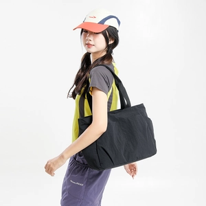 Black large capacity nylon tote bag shown on model for casual everyday commute