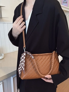 Chic brown woven leather shoulder bag with polka dot scarf accessory for women