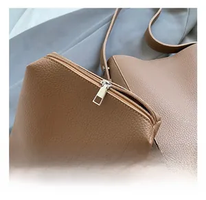 Detail of the high-quality silver zipper and lychee grain leather on the retro bucket bag