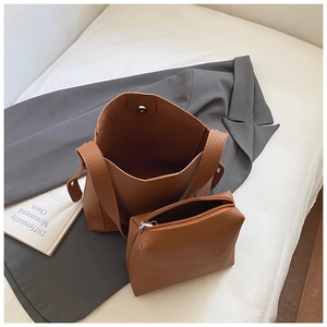 Detail of caramel brown litchi pattern PU leather tote bag and inner pouch set