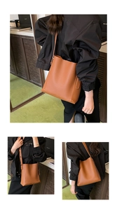 Detailed views of a brown pebbled leather bucket bag showing its size and shoulder carry style