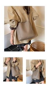 Detailed macro view of taupe lychee pattern leather bucket bag with natural texture finish