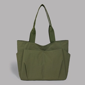 Detailed close-up of dark olive green tote bag showing reinforced texture and wide straps