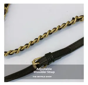 Close-up of adjustable black leather strap and golden chain detail on a handbag