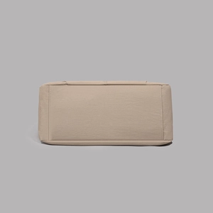 Detailed view of durable khaki tote bag base featuring reinforced stitching and large capacity