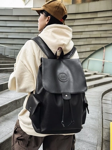 Large black vintage leather backpack with drawstring closure and side pockets for travel