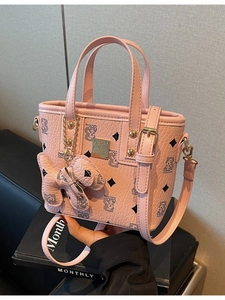 Pink pebbled leather bucket bag with bear print and adjustable crossbody strap