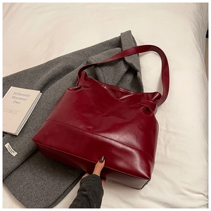 Detail of burgundy PU leather tote bag showing soft texture and premium stitching