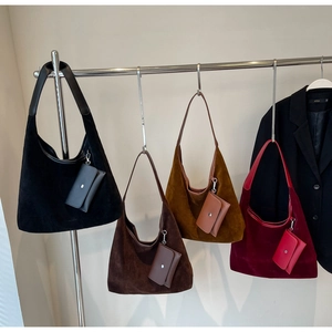 Detail view of retro suede hobo bags in four colors with matching coin purses
