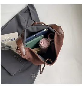 Top-down view of a spacious brown suede tote bag showing tablet and umbrella storage space