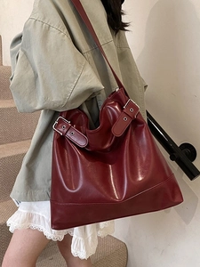 Large burgundy leather hobo tote bag for women with decorative buckles and glossy finish