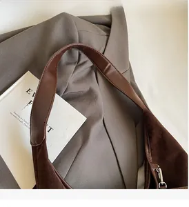 Detailed view of dark coffee tote bag showing premium suede leather and sturdy handle