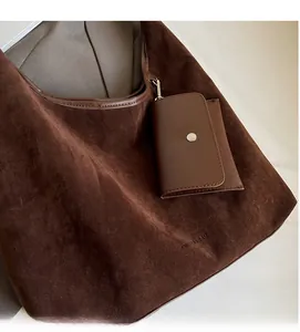Detail view showing soft dark brown suede fabric texture of a large hobo tote bag
