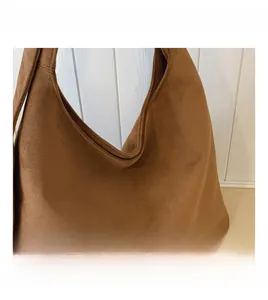 Detail shot of the brown leopard print tote bag with a soft matte suede texture and finish