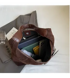 Macro view of the spacious interior compartment of a vintage brown suede tote bag