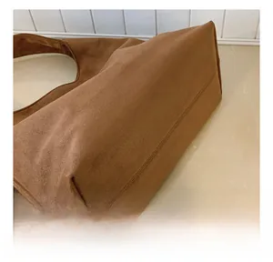 Close-up showing the precise reinforced stitching on a brown leopard tote bag base