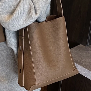 Vintage brown textured leather bucket bag with wide shoulder strap for women