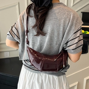 Deep burgundy glossy croissant bag for women with quilted design and knotted shoulder strap