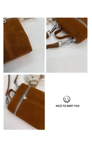 Makroansicht der braunen Wildleder-Zylindertasche mit silbernen Reißverschlüssen