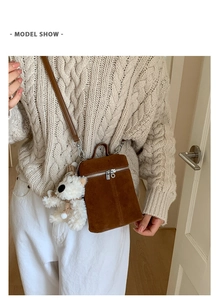 Braune matte Wildleder-Eimertasche am Modell mit Strickpullover für Winter-Look