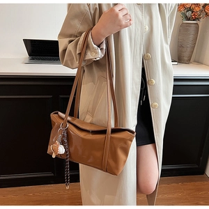 Brown faux leather tote bag with unique mushroom charm detail and fashion logo
