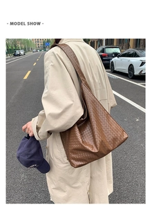 Deep brown woven leather tote bag with large capacity shown in a daily street style setting