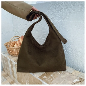 Detail of matte suede texture on the dark olive hobo tote bag with gold metal buckle