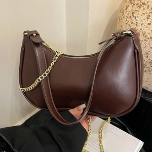 Dark brown half-moon hobo bag with gold metal chain strap for women in 2025 summer style