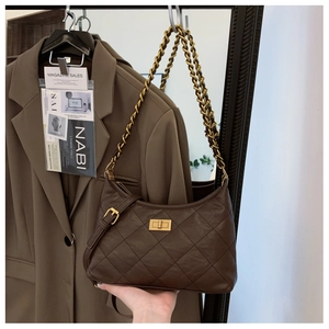 Close-up of dark brown quilted leather bag with gold chain strap and metal clasp