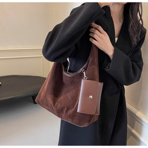 Detailed view of brown suede shoulder tote bag with matching leather coin purse accessory