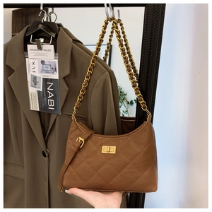 Close-up of brown quilted hobo bag with gold chain strap and metal turn-lock closure