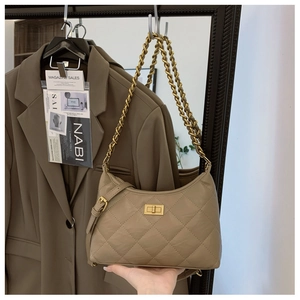Detail of khaki quilted dumpling bag with gold twist lock and metallic chain strap