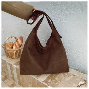 Close-up of deep brown suede hobo tote bag showing large capacity and soft texture