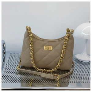 Detail of khaki quilted chain bag featuring gold twist lock and metallic chain strap