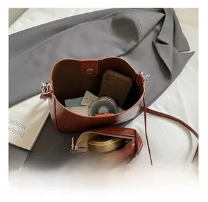 Detail view of vintage brown bucket bag interior capacity and matching zipper pouch