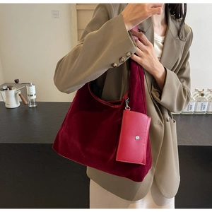 Detail view of burgundy velvet hobo bag with matching leather coin purse and metallic buckle