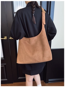 Rear view of brown suede tote bag showing large capacity and soft texture drape