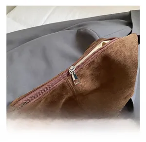 Close-up of brown suede tote bag featuring high-quality silver metal zipper details