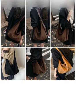 Outdoor street photography showing the large suede hobo bag worn in multiple classic colors