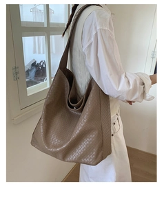 Detail of deep apricot woven hobo bag showing texture and large capacity for daily use