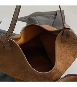 Detailed top view of a large brown suede tote bag featuring a spacious open interior