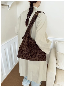 Detail showing the adjustable bronze buckle on leopard print shoulder bag strap