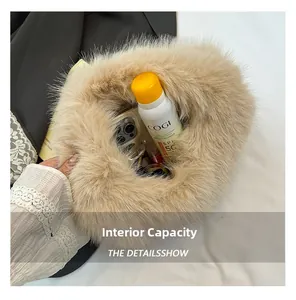 Internal capacity of beige plush dumpling bag showing phone and cosmetics space