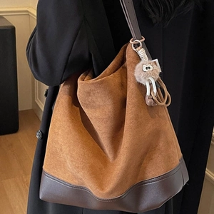 Retro large capacity tote bag with brown suede and leather stitching worn by a model