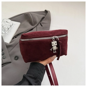 Detail of burgundy suede square bag with silver zipper and robot charm detail