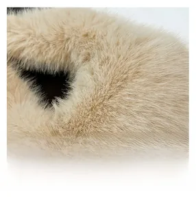 Close-up macro view of the soft beige faux fur texture on this trendy handbag